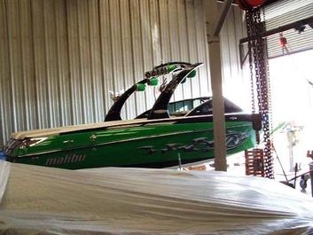 Inside warehouse ski boat lift with Malibu Ski Boat